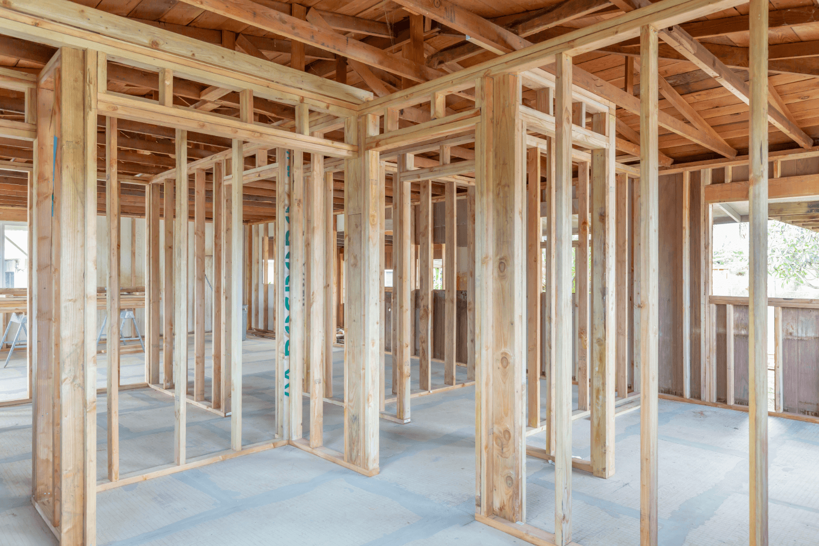Interior of a house with wood studs exposed showing wood frame